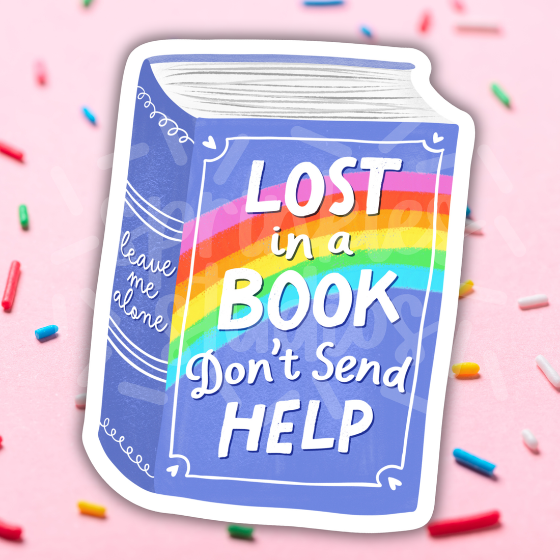 Book-shaped sticker with rainbow text on a pink background with colorful sprinkles