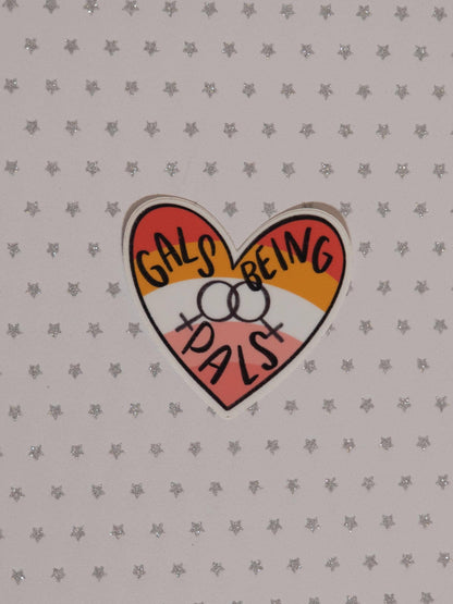 A heart-shaped sticker with the text &