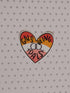 A heart-shaped sticker with the text &