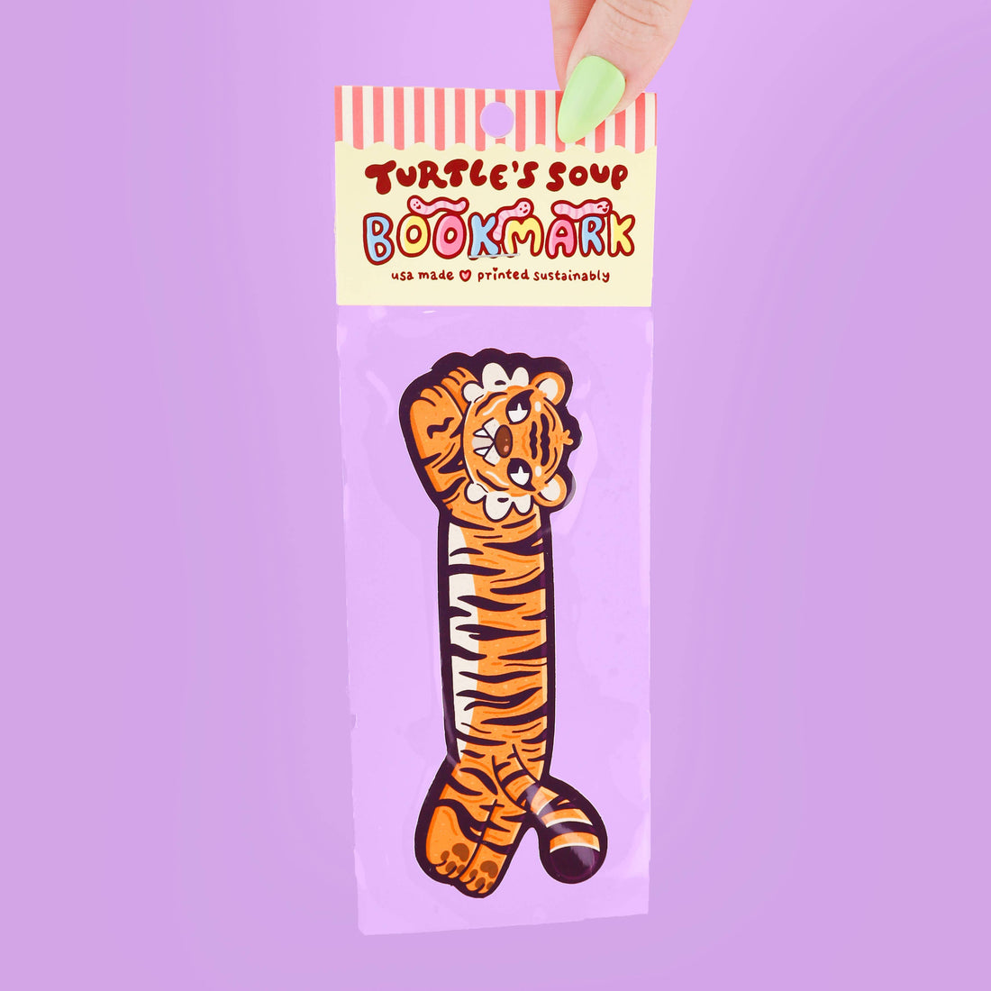 Bookmark with tiger design in packaging on a purple background