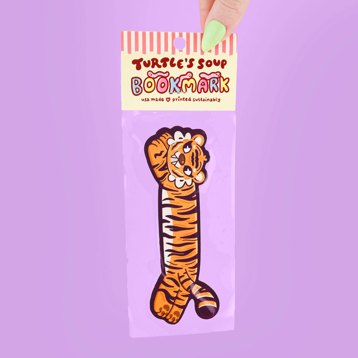 Bookmark with tiger design in packaging on a purple background