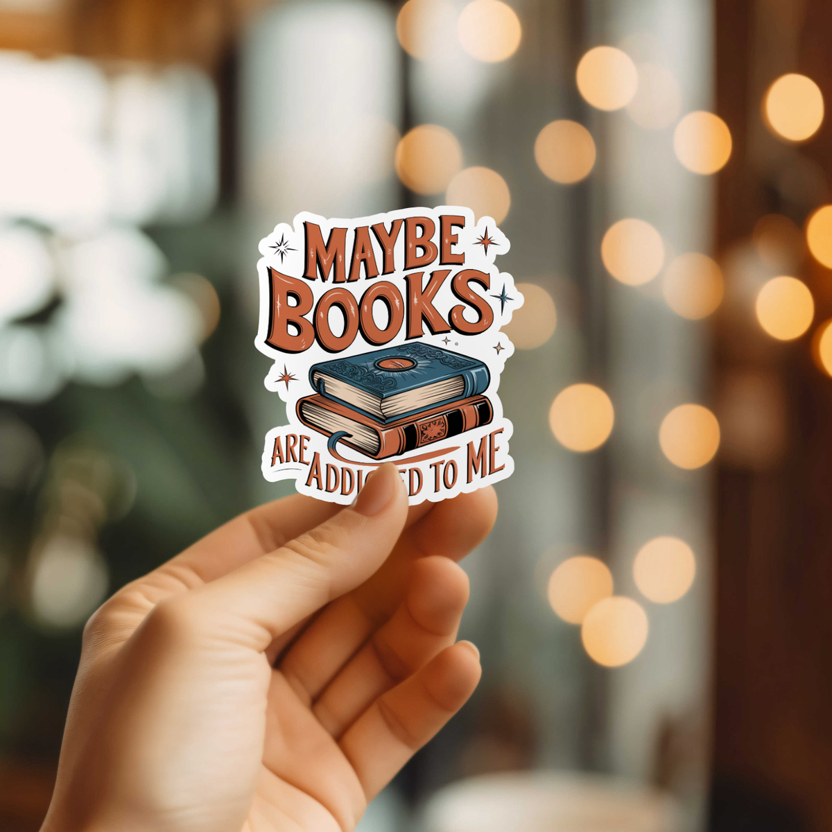 Hand holding a sticker with &
