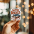 Hand holding a sticker with &