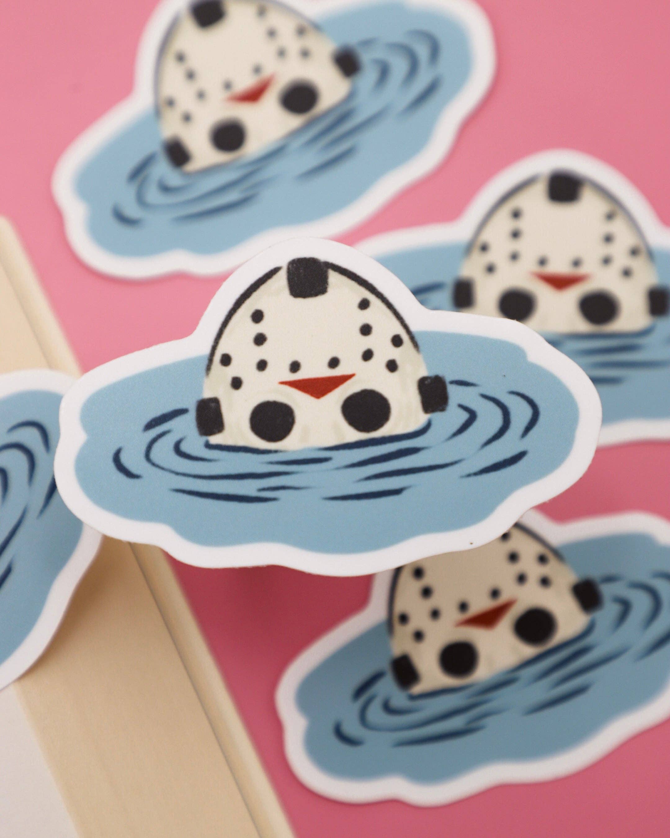Stickers of a cartoon character with polka dot snowman hat in water on a pink background