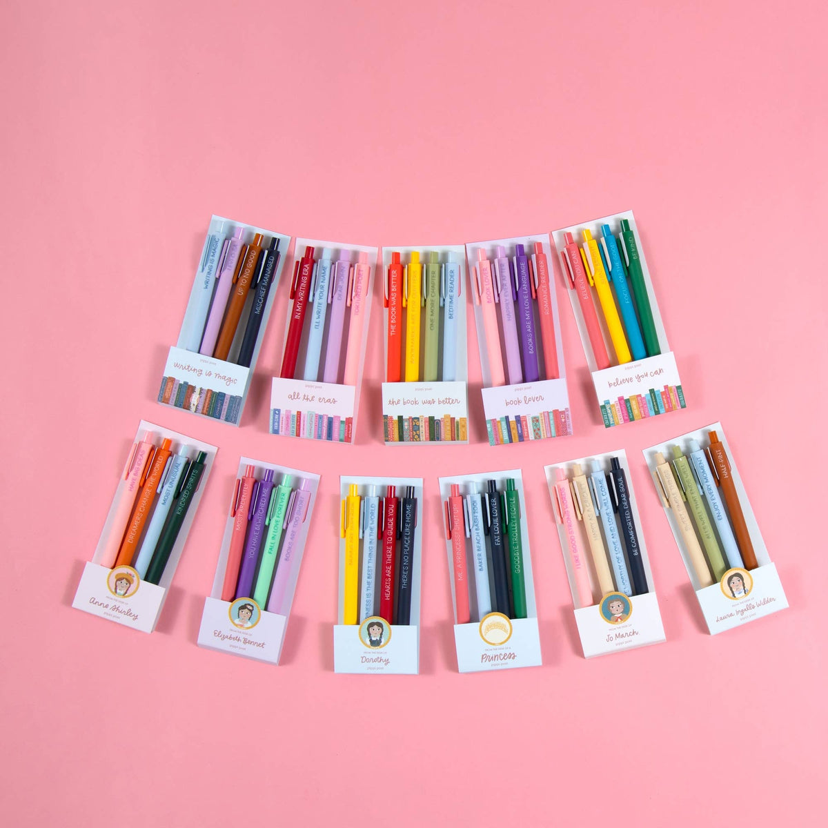 Set of colorful pens in their packaging on a pink background