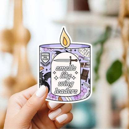 Hand holding a sticker with a candle design and text &