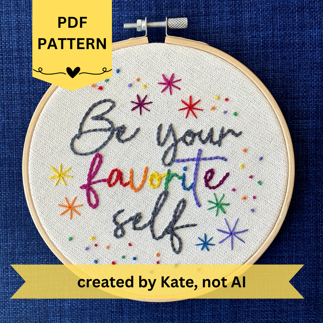 PDF Pattern created by Kate, not AI. "Be Your Favorite Self" is hand embroidered in a script font on cream fabric. Favorite is sewn in rainbow colors, be your and self are embroidered in dark gray, and stars surround the quote. This wall art is framed in a light wood embroidery frame.