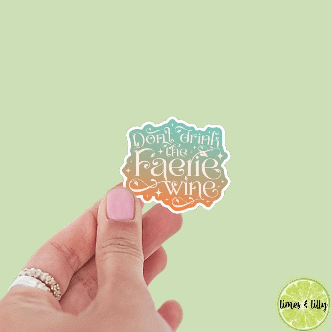 Hand holding a sticker with &