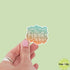 Hand holding a sticker with &