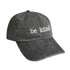 Faded black cotton dad hat with white "be kind." embroidery and a relaxed, vintage-inspired look