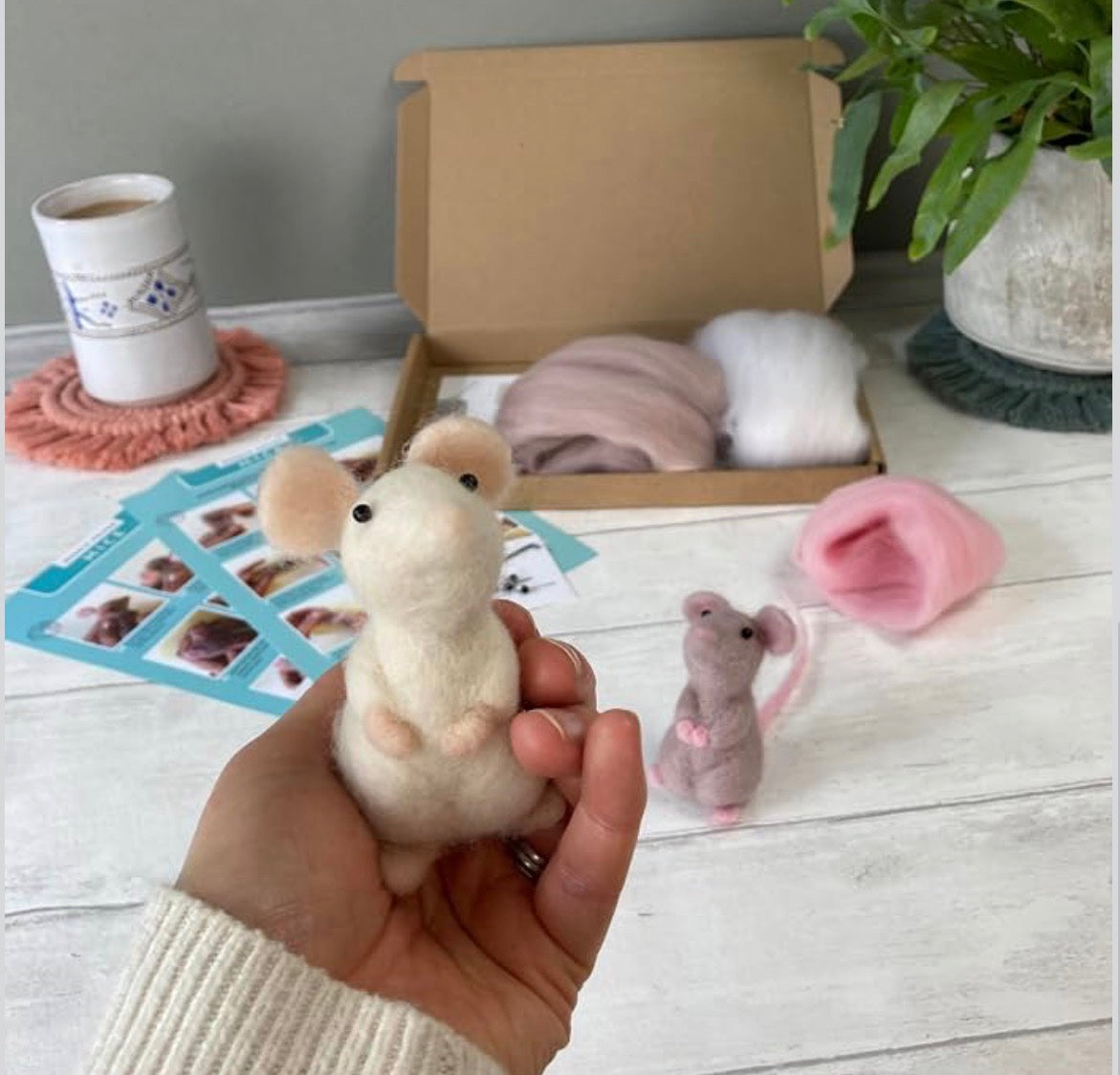 Hand holding a finished needle-felted mouse next to the Bergin &amp; Bath kit
