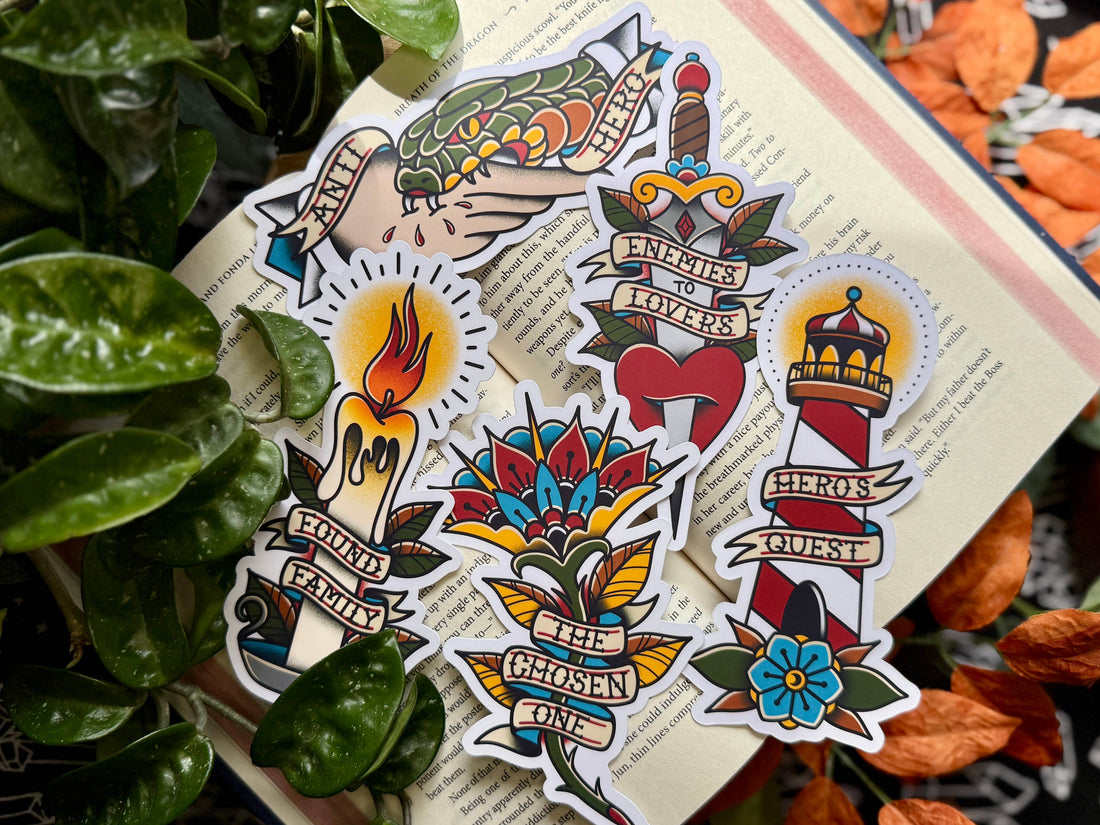 Collection of colorful tattoo-style stickers on a textured surface with leaves and flowers in the background.
