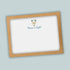 A brown frame with a white background inside, containing a graphic of a menorah with blue and gold accents and the text "Peace & Light" below it.
