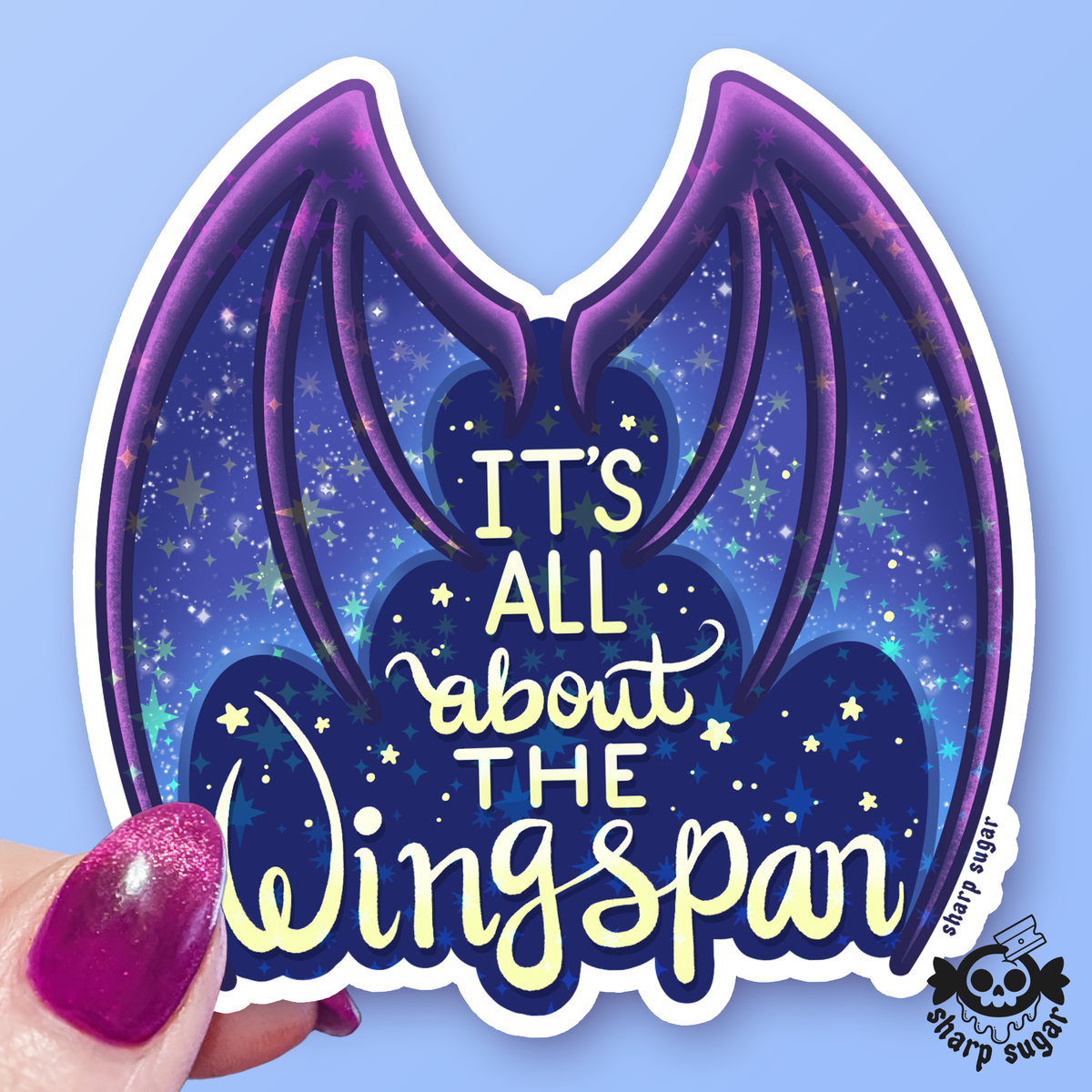 A die-cut vinyl sticker featuring purple bat wings on a starry blue night-sky background with the text &