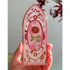 Decorative bookmark with a rose design held in a hand against a neutral background