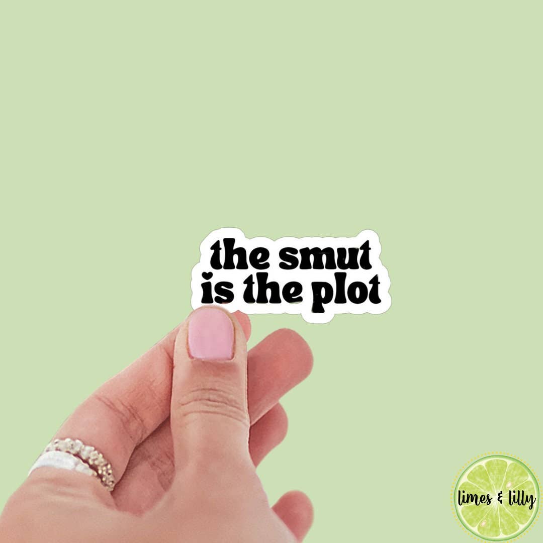 Hand holding a sticker with &