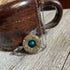 The Jasper Mood Bead Necklace | Color-Changing Mood Jewelry on Silver Chain is a handmade piece with a blue center pendant, shown resting against a rustic brown ceramic mug on a wooden surface.
