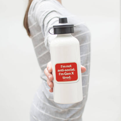 Person holding a white water bottle with a red sticker on a plain background