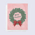 a greeting card that says "merry christmas" framed by a green wreath with a red bow
