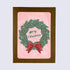 A folded greeting card with a Christmas wreath design and &