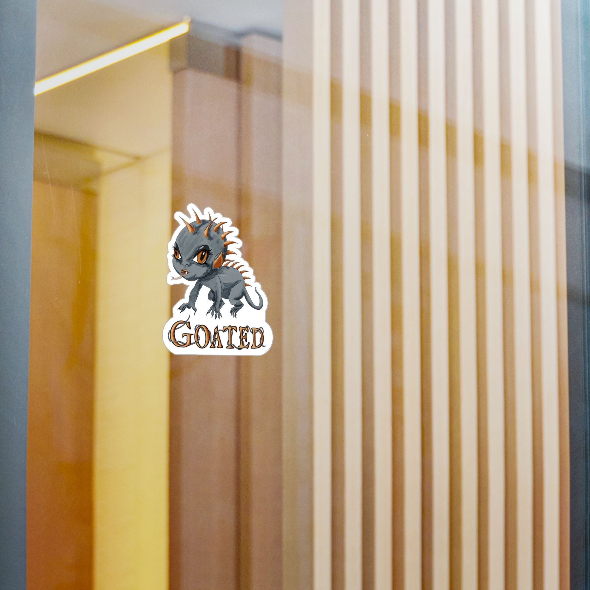 Small chupacabra cryptid sticker on a glass window in a modern interior