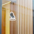 Small chupacabra cryptid sticker on a glass window in a modern interior