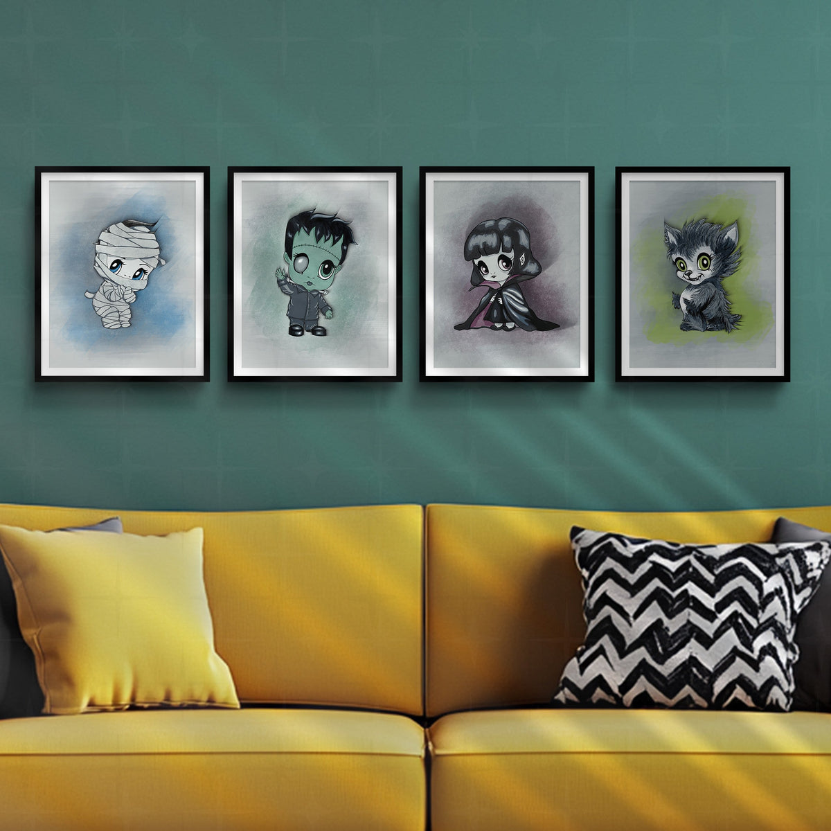 Four framed monster art prints hung in a horizontal row on a teal wall above a mustard yellow sofa with black and white chevron pillows.