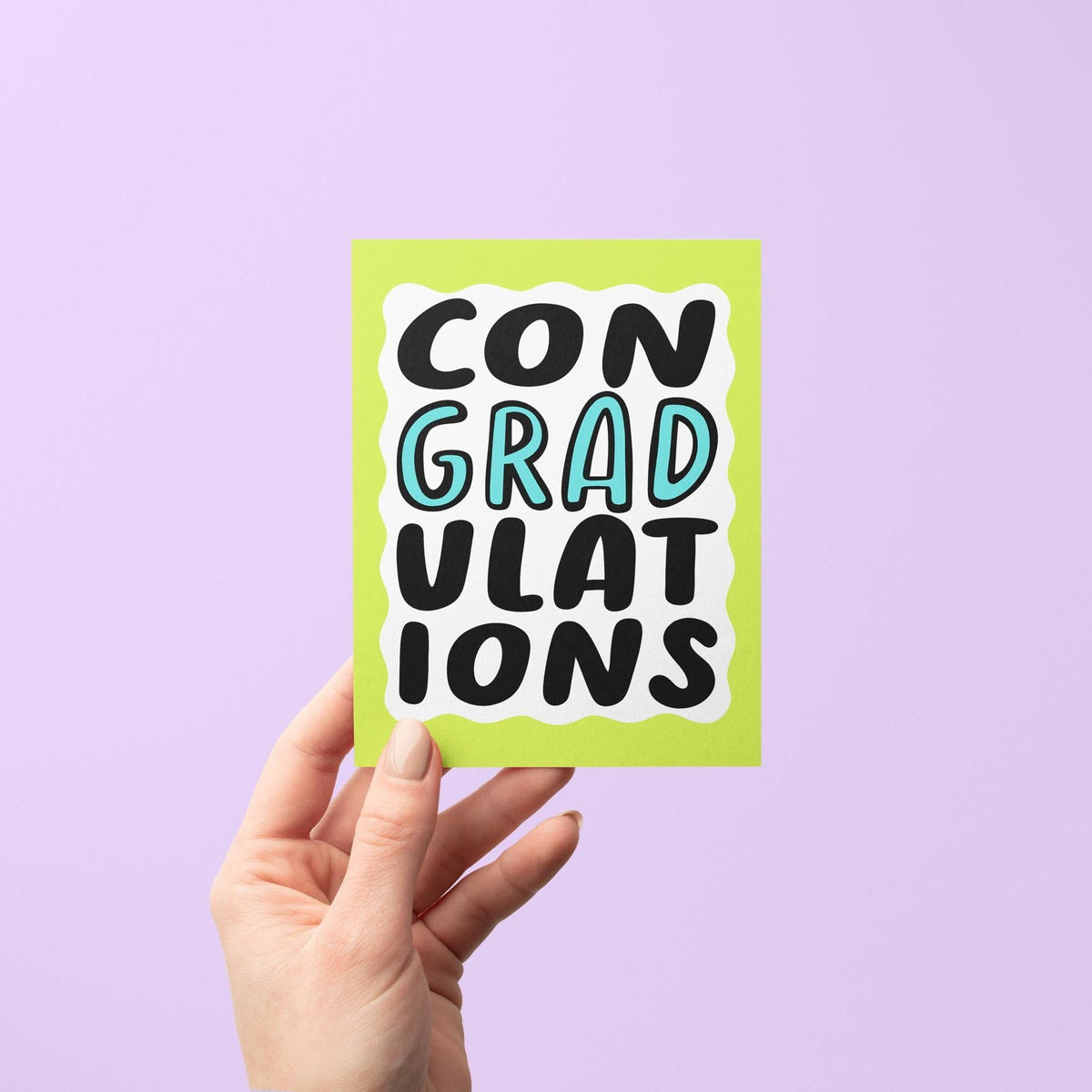 ConGRADulations graduation card flat lay — funny graduation congratulations card for a grad, by indie artist MangoIllustrated