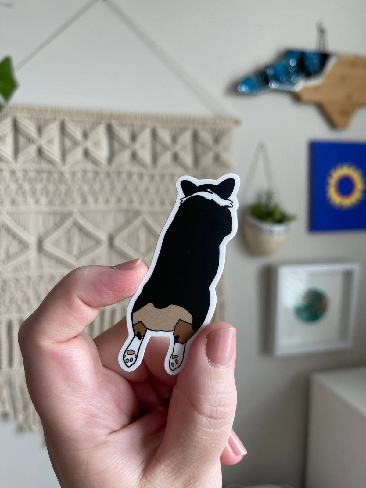 Corgi Sploot sticker — illustrated tri color Pembroke Welsh corgi splooting with legs out behind her, waterproof vinyl sticker, by MangoIllustrated