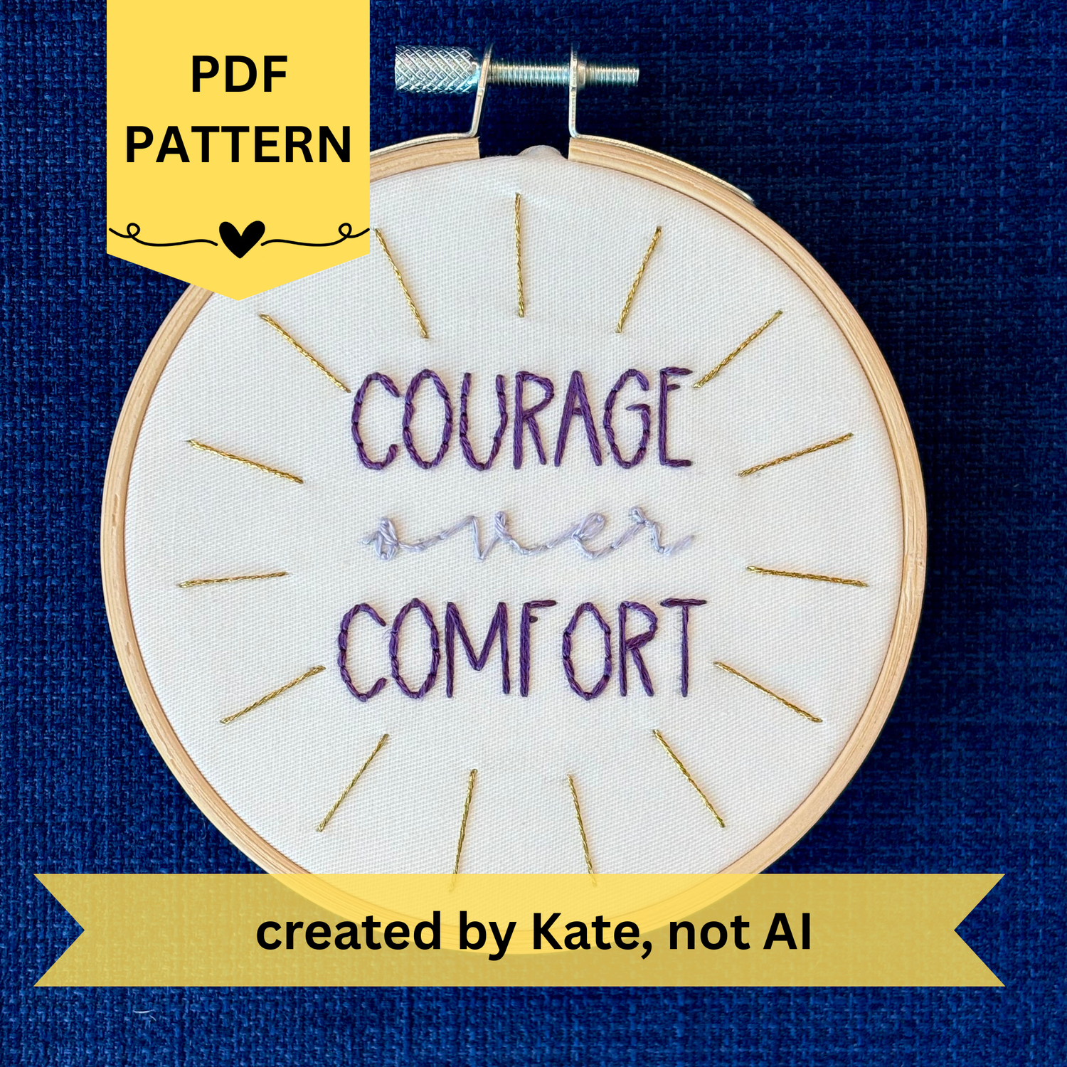 PDF pattern created by Kate, not AI. "Courage over comfort". "courage" and "comfort" are hand embroidered in dark purple embroidery thread and are all capital letters in a print handwriting font. "over" is stitched in light purple embroidery floss in a lowercase cursive handwriting font. Quote is centered in a burst of metallic gold rays. Fabric is white cotton. Framed in light wood embroidery hoop as wall art or Christmas ornament.
