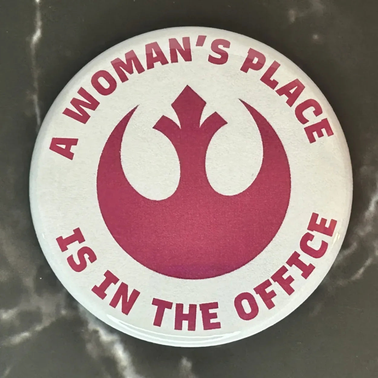 A woman’s place is in the office button