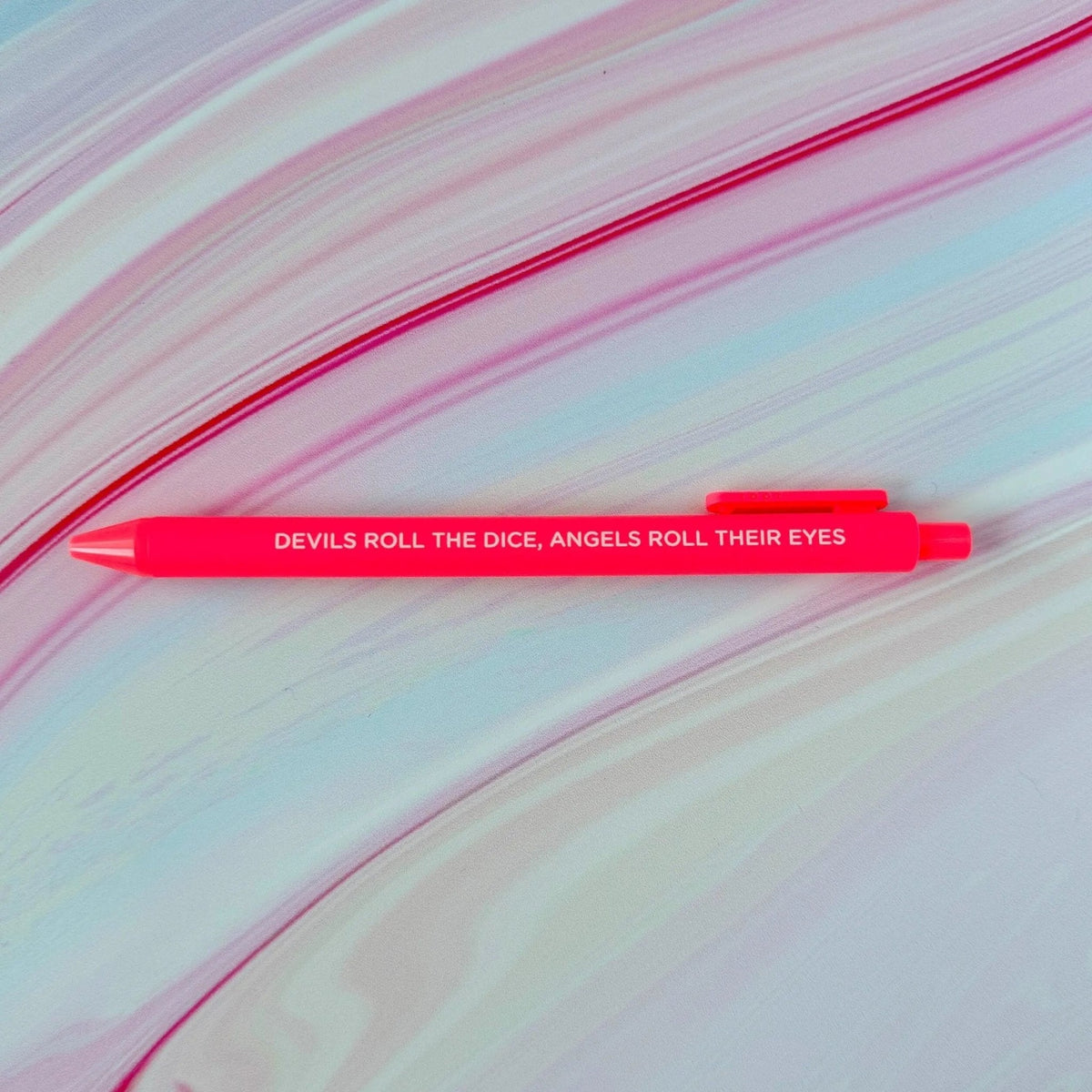 Cruel Summer jotter gel pen flat lay — devils roll the dice neon coral gel pen by indie artist MangoIllustrated