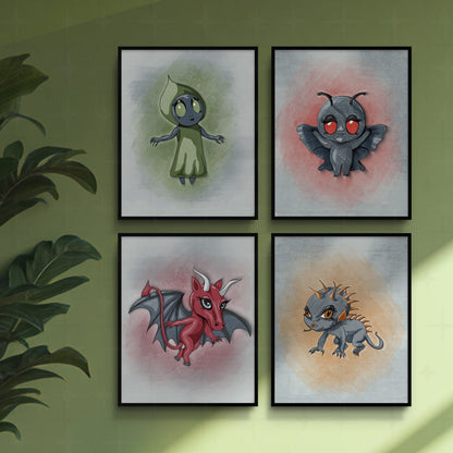 Set of 4 cryptid art prints in thin black frames on a sage green wall beside a leafy houseplant, arranged as a square gallery wall.