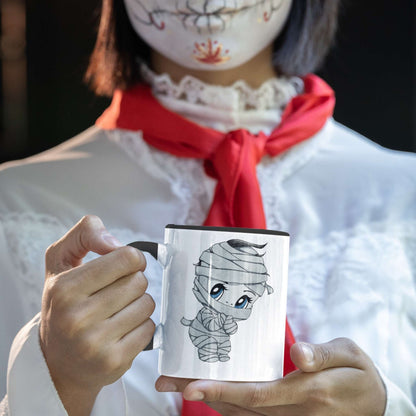 Person in Halloween costume holding the cute mummy coffee mug with a chibi bandaged character