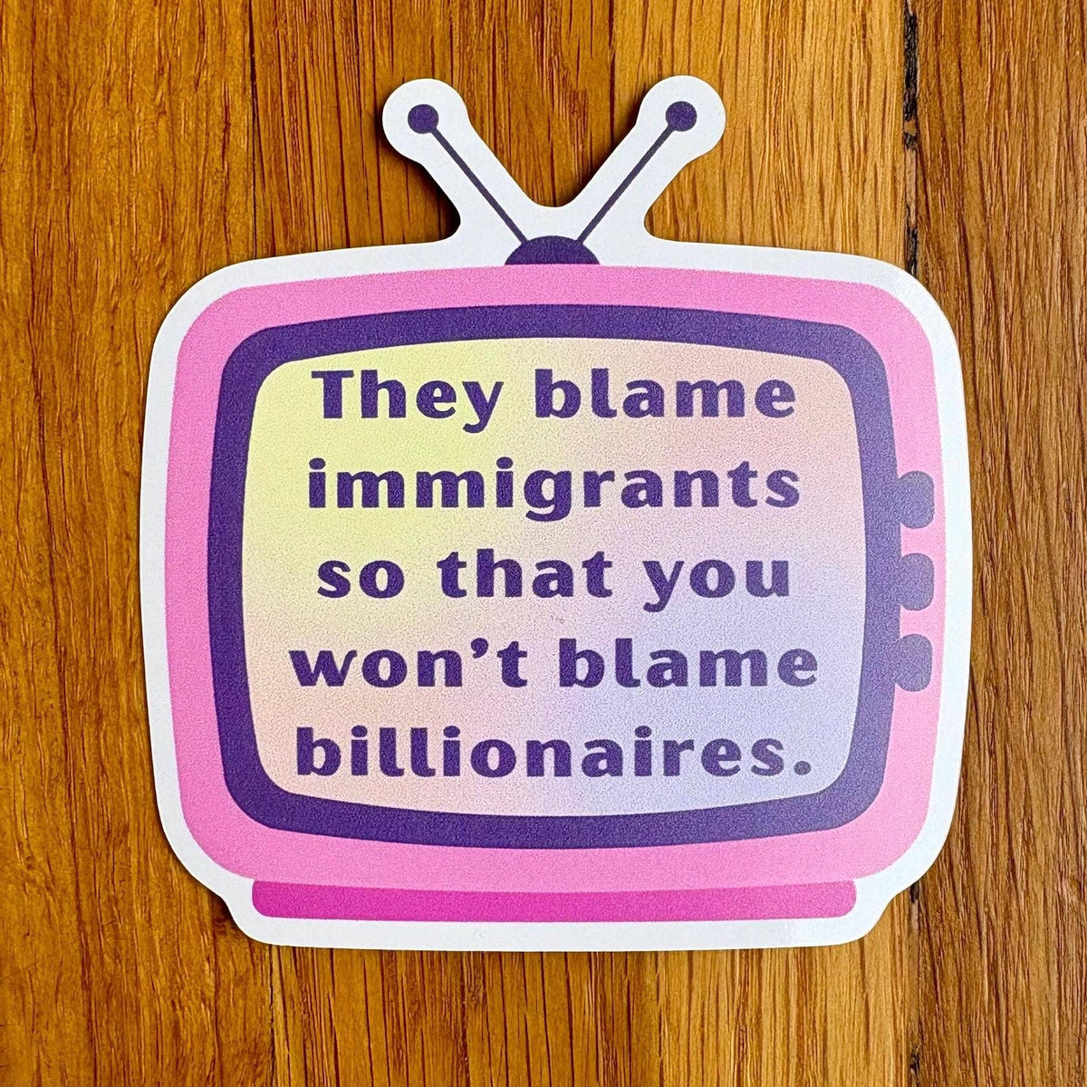 A die-cut sticker shaped like a retro television with the text &