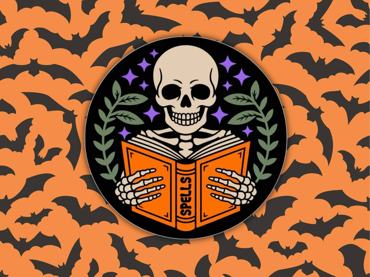 A circular Halloween-themed graphic featuring a skull skeleton holding an orange book labeled &