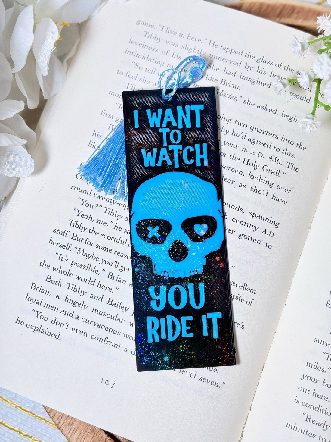 Bookmark with skull design and text on an open book