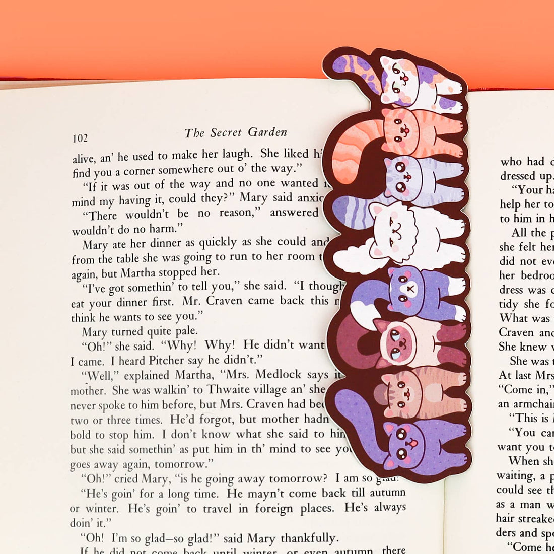 Bookmark with cartoon cat designs on a book page