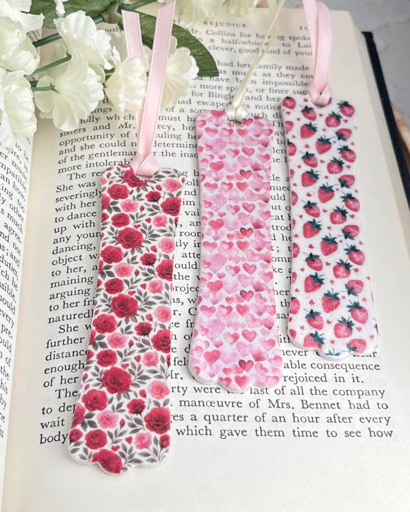 Floral bookmarks on a book with white flowers.