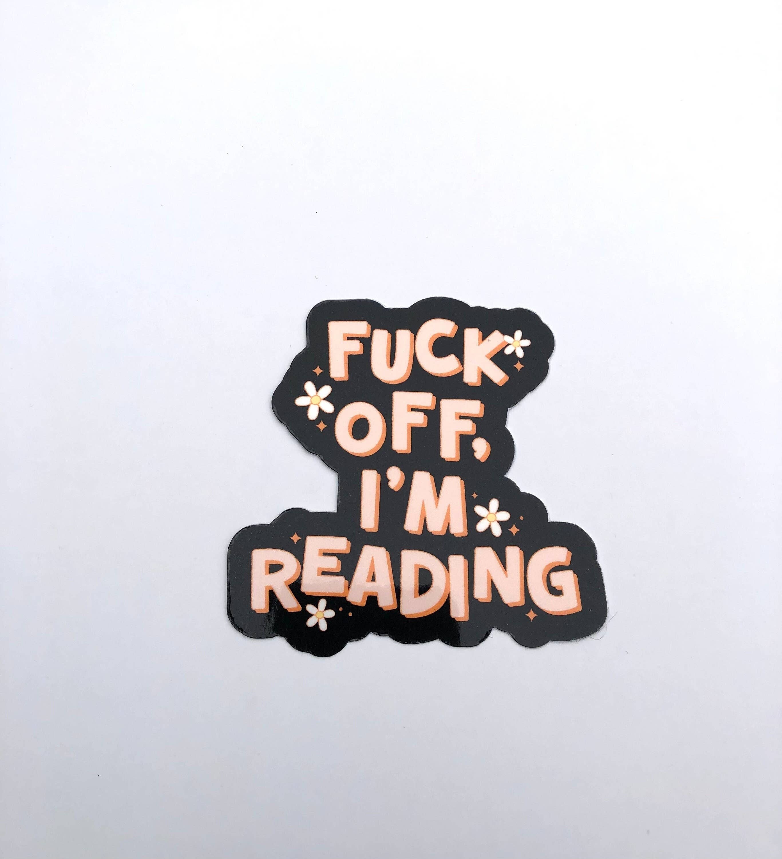 A die-cut sticker with the text &