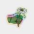A die-cut sticker featuring a stitched green hand holding a white daisy with the text &