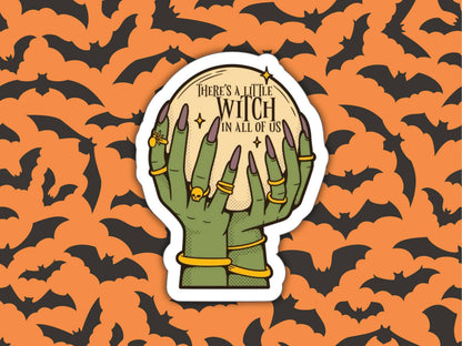 A die-cut sticker featuring two green skeletal hands holding a glowing moon with the text &