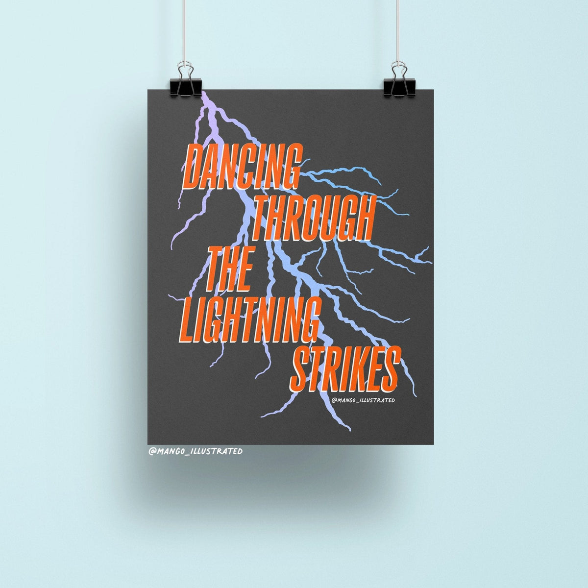 Dancing Through the Lightning Strikes art print flat lay — bold black and orange wall art for a bedroom gallery wall by indie artist MangoIllustrated