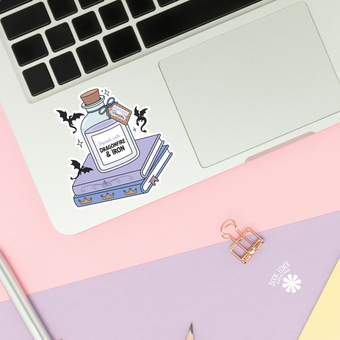 Sticker of a potion bottle on a laptop with a pink and purple background