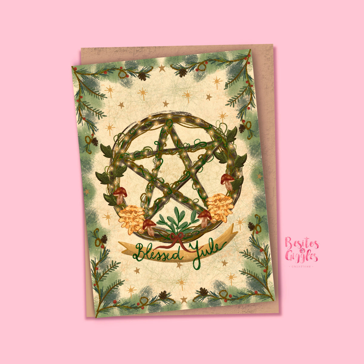 A square greeting card with a kraft envelope, featuring a green pentagram wreath, pine branches, and the words &