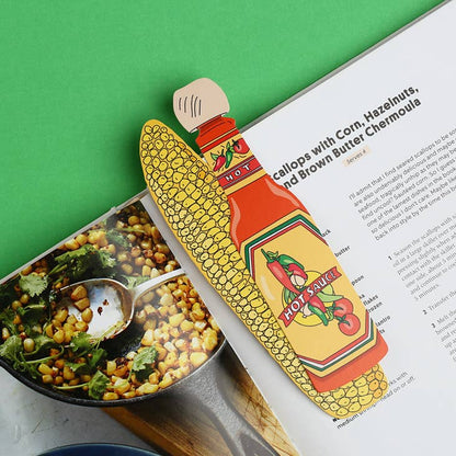 Corn-shaped hot sauce bottle with a label on a magazine page