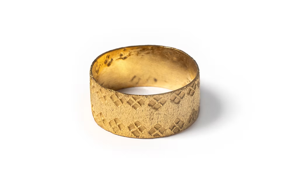 Hand made gold vermeil ring with a textured finish and hand stamped design, through fair trade partnerships in mexico, flat lay, ethical artisan ring jewelry chicago 