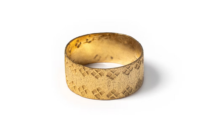 Hand made gold vermeil ring with a textured finish and hand stamped design, through fair trade partnerships in mexico, flat lay, ethical artisan ring jewelry chicago 
