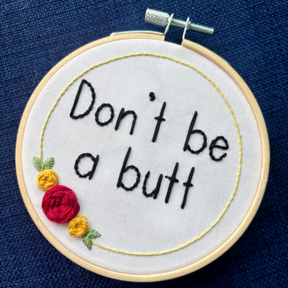 Embroidery hoop reads, "Don&