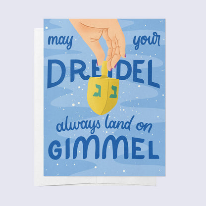 A greeting card with a blue background featuring a graphic of a dreidel and the text &